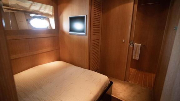 Among Cannes daily yacht rental options Best Mountain cabin shows bed and TV for comfortable stay.