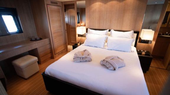 Among Cannes daily yacht rental options Best Mountain cabin shows large double bed with elegant interior.