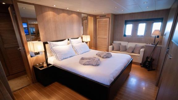 Among Cannes daily yacht rental options Best Mountain cabin shows large bed with seating area.