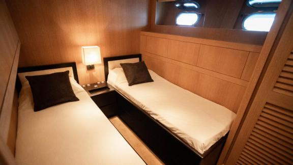Among Cannes daily yacht rental options Best Mountain cabin shows twin beds for comfortable accommodation.