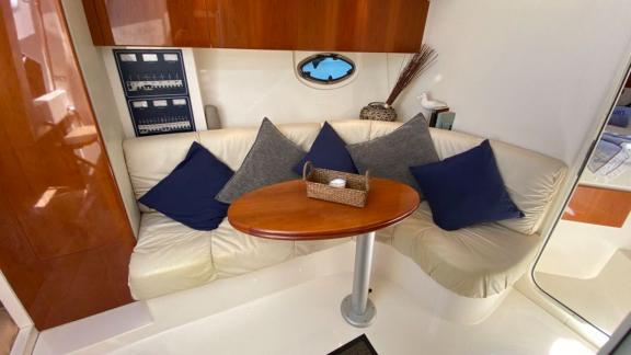 Cozy seating area in the salon of motor yacht Black Ball, decorated with stylish cushions.