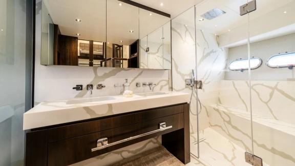 Among Spain yacht charter options Blue Infinity One 5 cabin yacht for 12 guests shows modern bathroom.