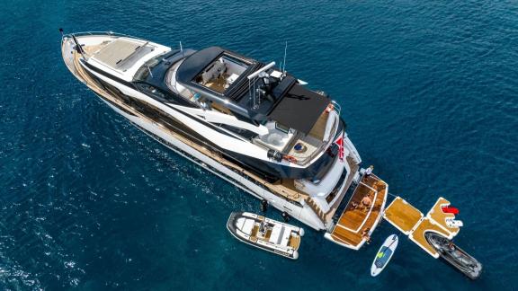 Among Mallorca yacht charter options Blue Infinity One shows aft platform with tender and water toys.