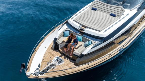 Among Spain yacht charter options Blue Infinity One shows bow seating and sea view.