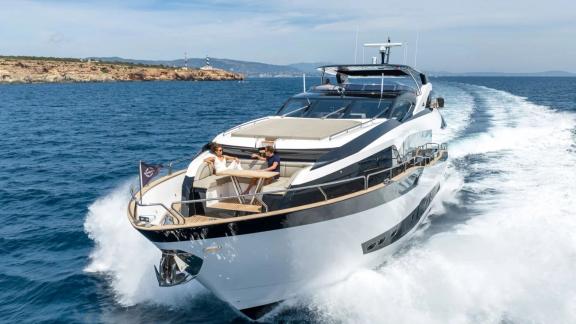Among Spain yacht charter options Blue Infinity One 5 cabin yacht for 12 guests shows bow seating with table.