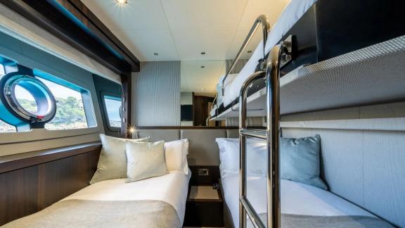 Among Spain yacht charter options Blue Infinity One 5 cabin yacht for 12 guests shows bunk cabin.