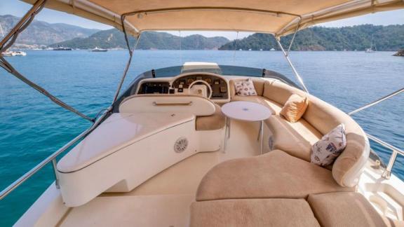 The upper deck of motor yacht Blue My Story offers comfortable seating and a wide view.