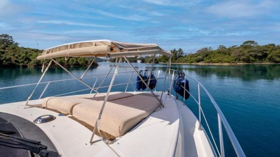 The foredeck of motor yacht Blue My Story offers comfortable loungers and a scenic view.