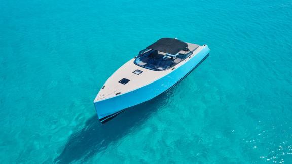 The Blue Steel motor yacht is anchored in clear and calm waters.