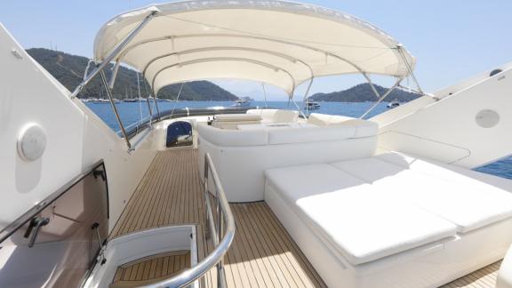 The spacious upper deck of motor yacht Bormus 2 offers comfort with cozy seating areas and captivating sea views.