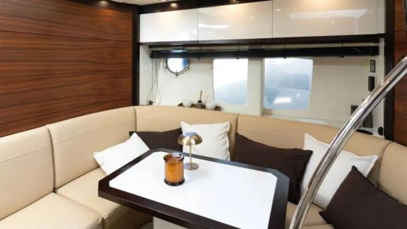 A stylish and cozy seating area decorated with pillows in the interior of Motoryacht Breathe.