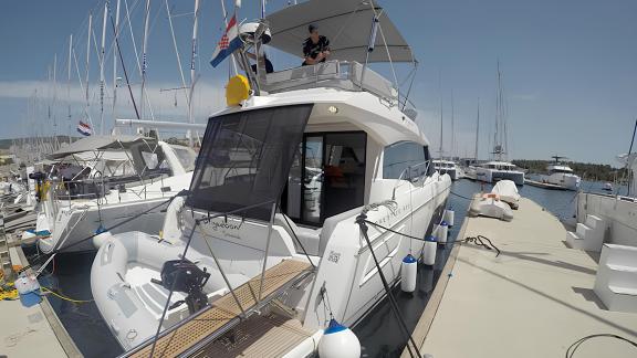 Die Motoryacht Brigadoon liegt im Hafen vor Anker, auf dem Oberdeck ist eine Person.