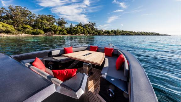 Among Monaco yacht charter options Cest Party motor yacht shows bow lounge with seating and table.