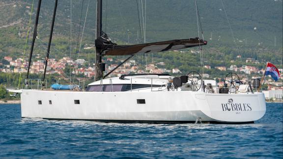 Among sailing yacht rental options in Kastela Bubbles is seen cruising with side profile and deck structure in open sea.
