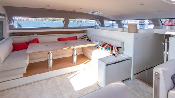 Among sailing yacht rental options in Kastela Bubbles interior seating and table area offers a bright and comfortable on