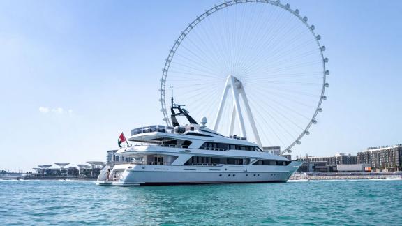 Code 8, a luxury yacht rental in Dubai, shines against the stunning Ain Dubai backdrop.