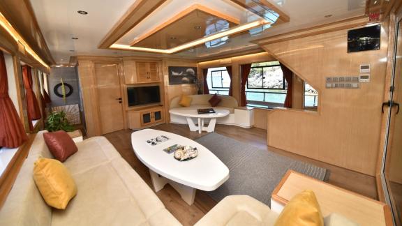 The spacious salon of the trawler Compass is furnished with comfortable seating areas and modern decor.