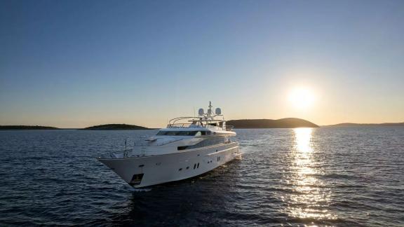 Horizon Elegance 115 Conte Stefani stands out on calm waters under the warm light of the setting sun.