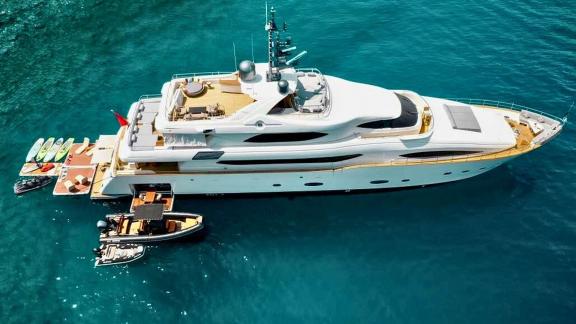 Yacht Ariela anchored in Göcek with paddleboards, jet skis and tender boats ready for charter.