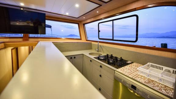 Among motor yacht rental options in Gocek Dalibay 2 kitchen shows stove sink and wide counter space onboard.
