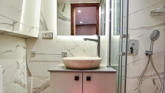 Among motor yacht rental options in Gocek Dalibay 2 bathroom shows sink shower cabin and modern interior onboard.