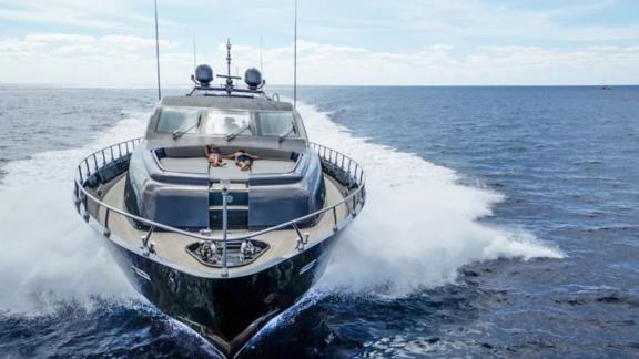 Motor yacht Dark Knight showcases its power and elegance as it speeds through the sea.