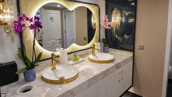 Den Den motor yacht in Bodrum features a stylish bathroom with modern sink and lighting for daily yacht rental comfort.