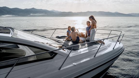 Guests are relaxing on the front deck of Discovery Bay motor yacht during a luxury yacht holiday in Monaco.