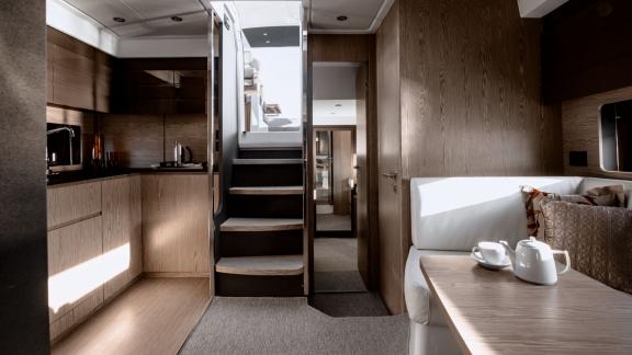Discovery Bay motor yacht features a modern kitchen area and a comfortable indoor lounge onboard.