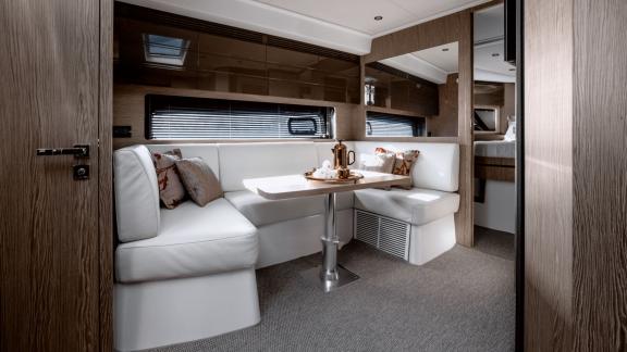 Discovery Bay motor yacht features a modern kitchen area and a comfortable indoor lounge onboard.