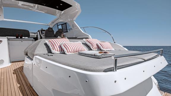Discovery Bay motor yacht features spacious sunbeds and a relaxing aft lounge area overlooking the sea.