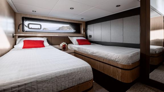 Discovery Bay motor yacht features a modern twin cabin with separate beds and comfortable accommodation onboard.