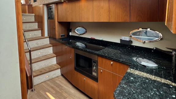 The kitchen of the Distraction motor yacht features marble countertops and modern appliances.