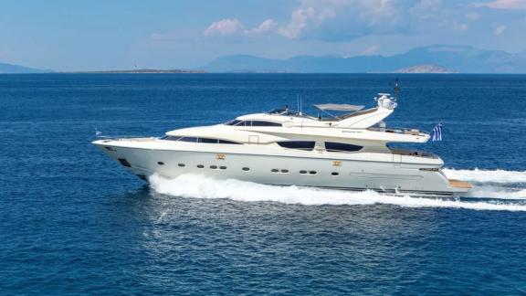 The luxury yacht Divine glides swiftly across the blue sea, showcasing elegance.