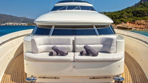 Comfortable seating area with towels on the front deck of the Divine yacht.