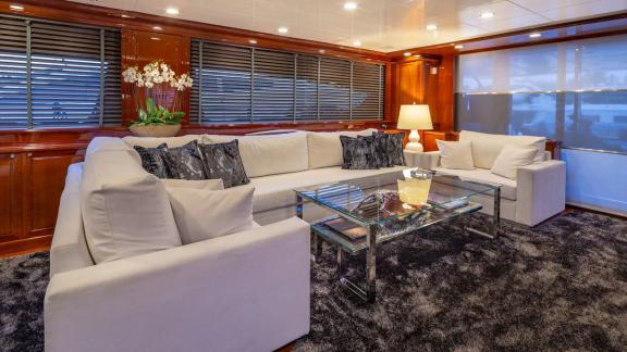 Spacious and comfortable seating area in the Divine yacht's salon, with elegant touches.