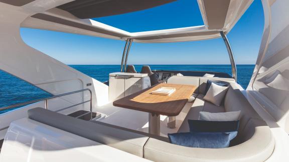 The spacious seating area on Emilia 2's flybridge offers relaxing moments with a sea view.