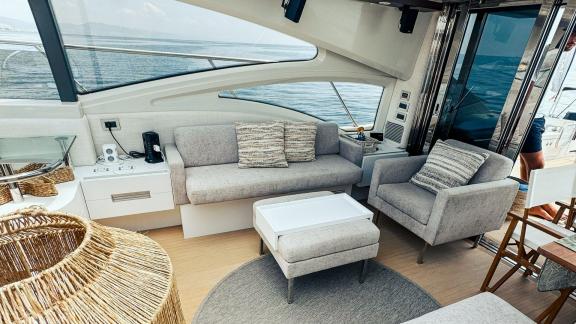 The lounge on motor yacht Esperanza features a comfortable seating area with sea views and modern decor.