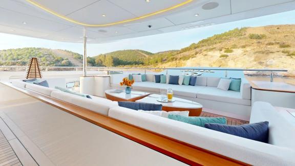 The spacious lounge area on Eternal Spark offers relaxing sea views during an exclusive yacht charter holiday.