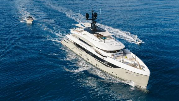 Eternal Spark motor yacht sails near Monaco with a tender boat during an exclusive yacht charter experience.