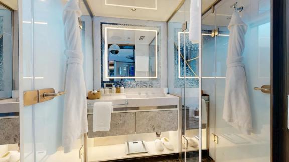 The bathroom on Eternal Spark features marble details and elegant comfort during luxury yacht charter stays.