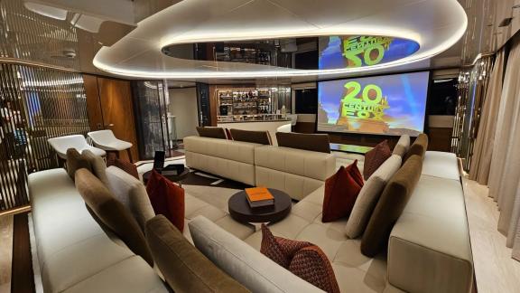 The private cinema area on Eternal Spark offers luxury entertainment and elegant seating during yacht charter stays.