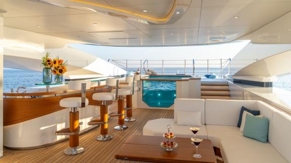 The bar and lounge area on Eternal Spark offers sea views and elegant comfort during yacht charter holidays.