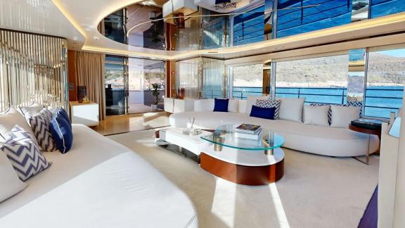 The elegant salon on Eternal Spark features panoramic windows and stylish seating for luxury yacht charter stays.