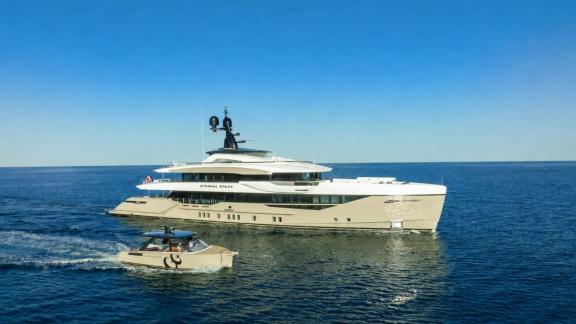 Eternal Spark motor yacht cruising along Monaco coast during a luxury yacht charter experience at sea.