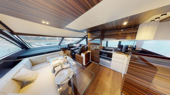 The modern kitchen and dining area of the Ferretti 670 motor yacht add elegance to your Dubai yacht rental experience.