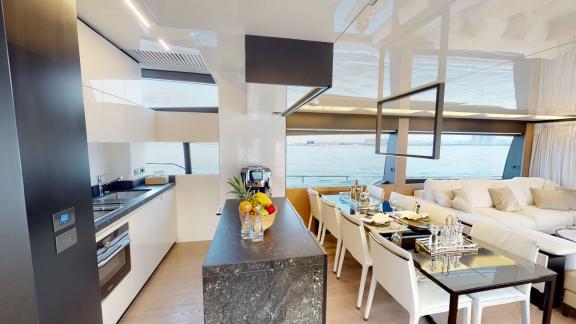 The kitchen and dining area of the Ferretti 780 motor yacht combine comfort and style for your Dubai yacht rental experi