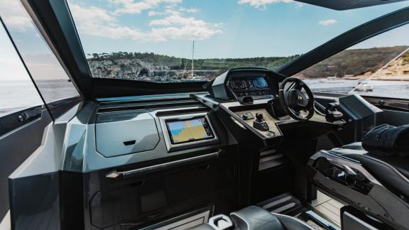 Modern helm station of the Figo motor yacht equipped with navigation systems.