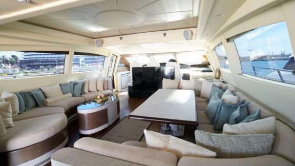 The spacious salon of motor yacht Five Stars features a comfortable seating area and a large table.