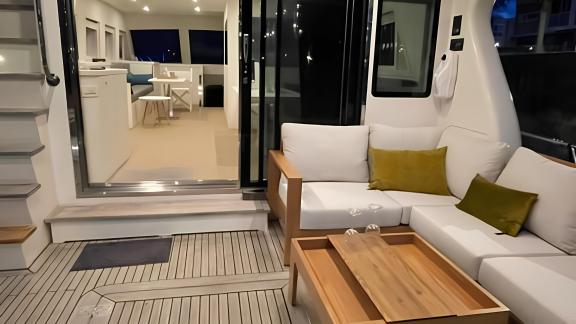 The aft deck of Flamenga offers a cozy seating area for evening relaxation and comfort.